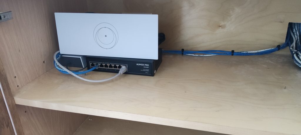 IMG_20250619_155821 Network switch and gateway with connected Ethernet cabling